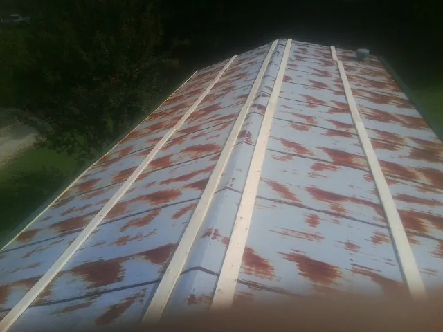 Rusted metal roof panels with new wood purlins before replacement — Storm Damage Roof Repair in Rimersburg by Roofing Brothers